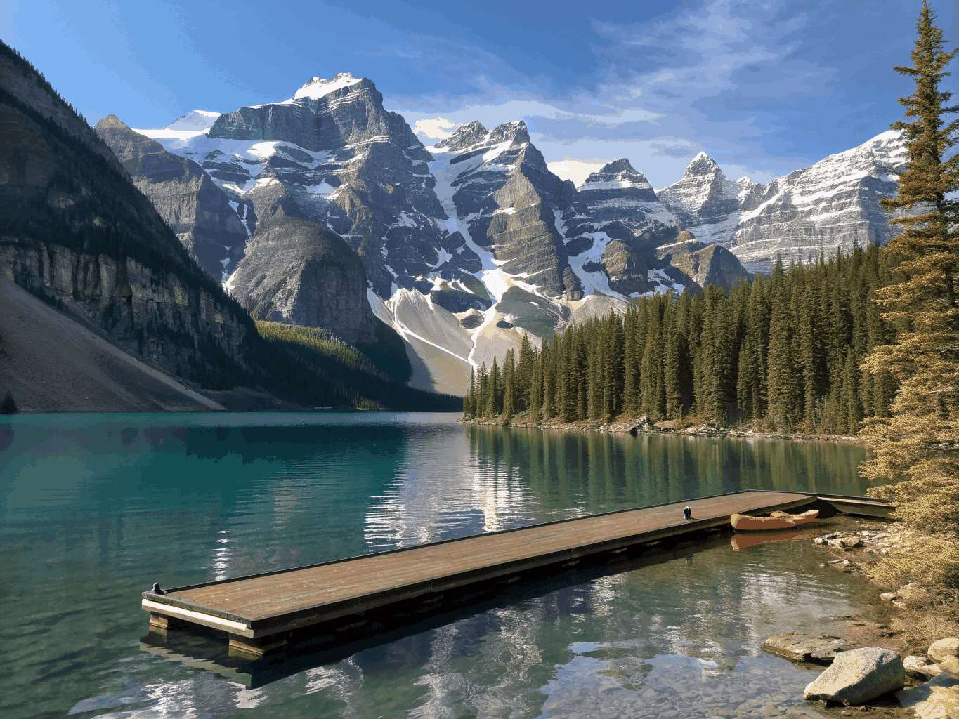 Pristine alpine lake bordered by pine forests and mountains in Banff, Canada