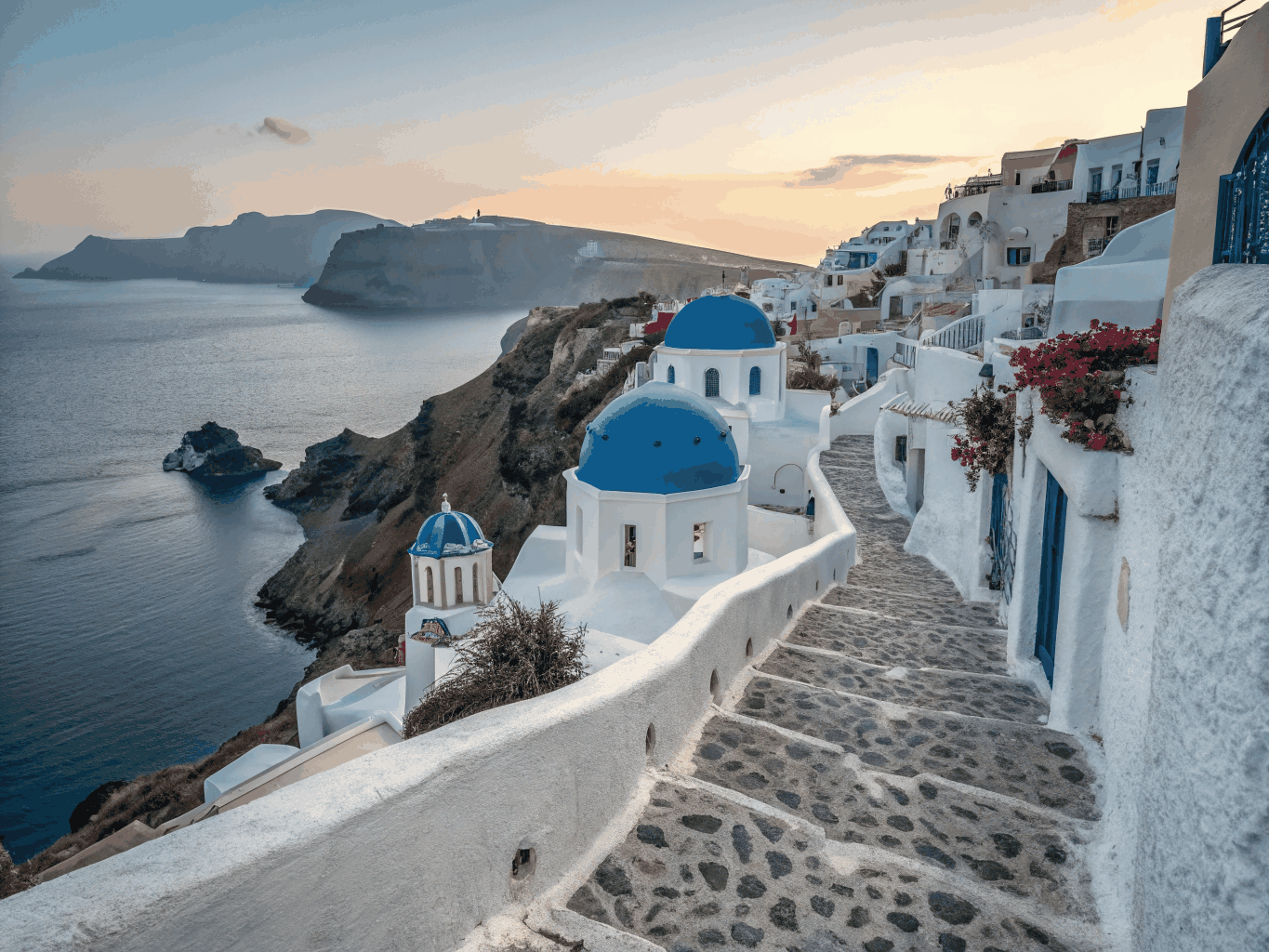 Whitewashed architecture and bright blue domes overlooking the Santorini caldera